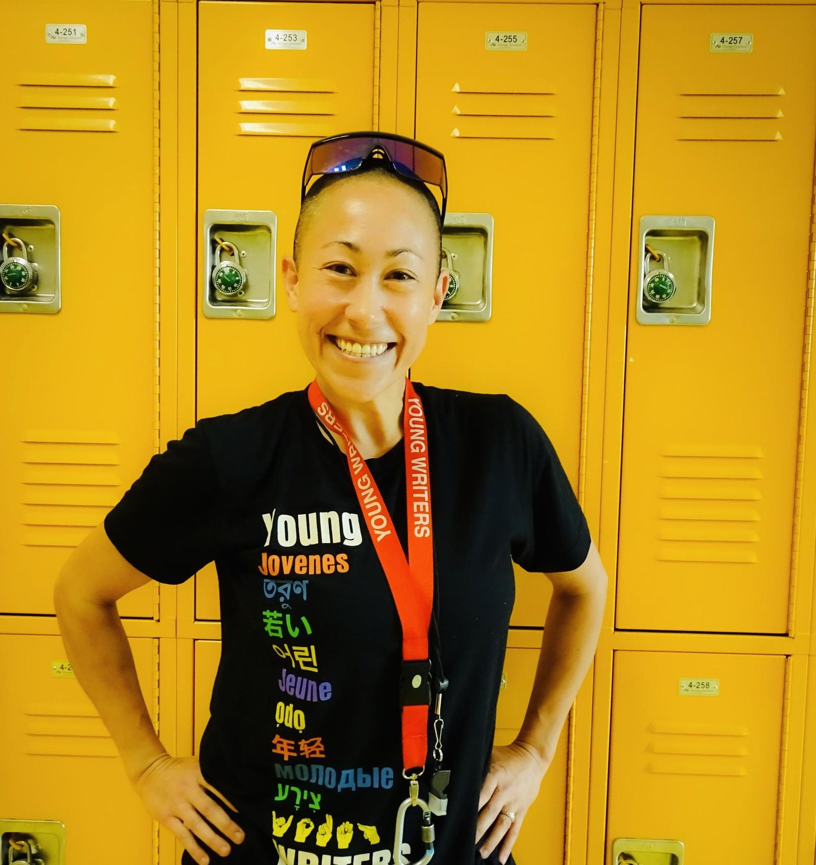 Young Writers program staff member smiling in school hallway