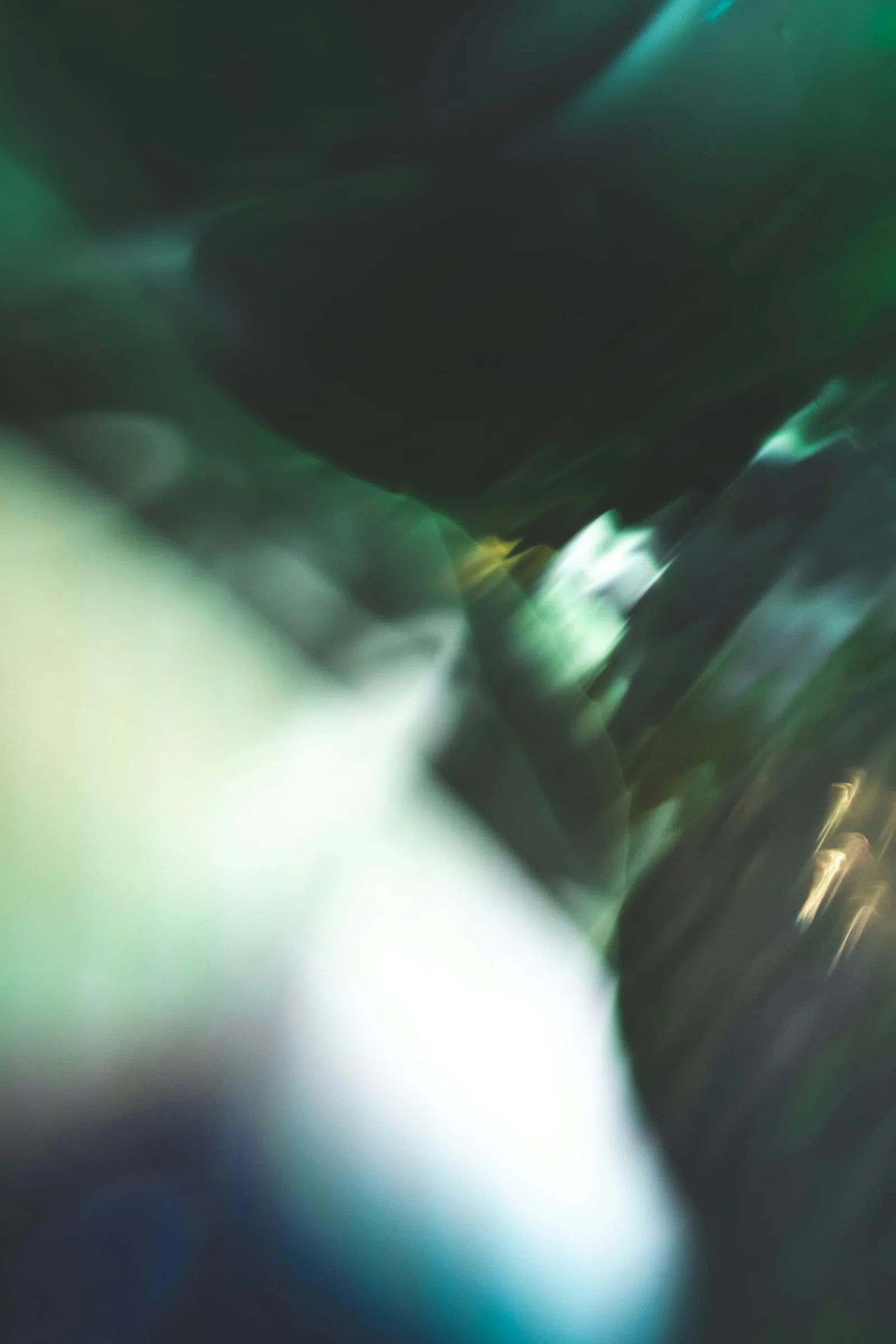 A blurred abstraction of green and white light in motion, New Beach journal