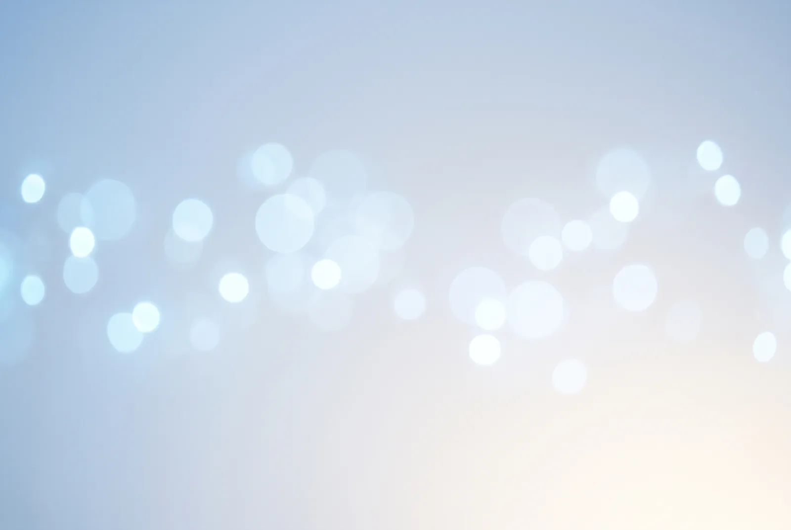 Pale blue and white circles of out-of-focus light drifting across a soft gradient, New Beach journal