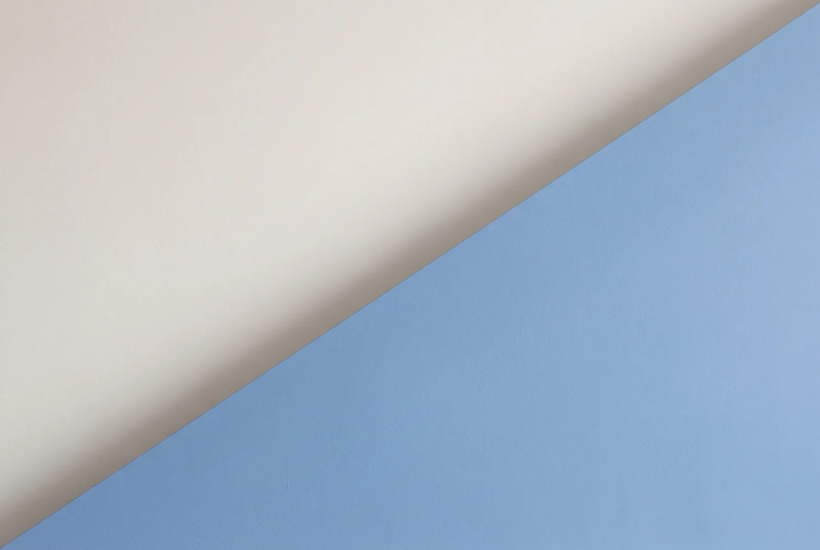 Two flat planes of colour, cream and pale blue, meeting along a clean diagonal, New Beach journal