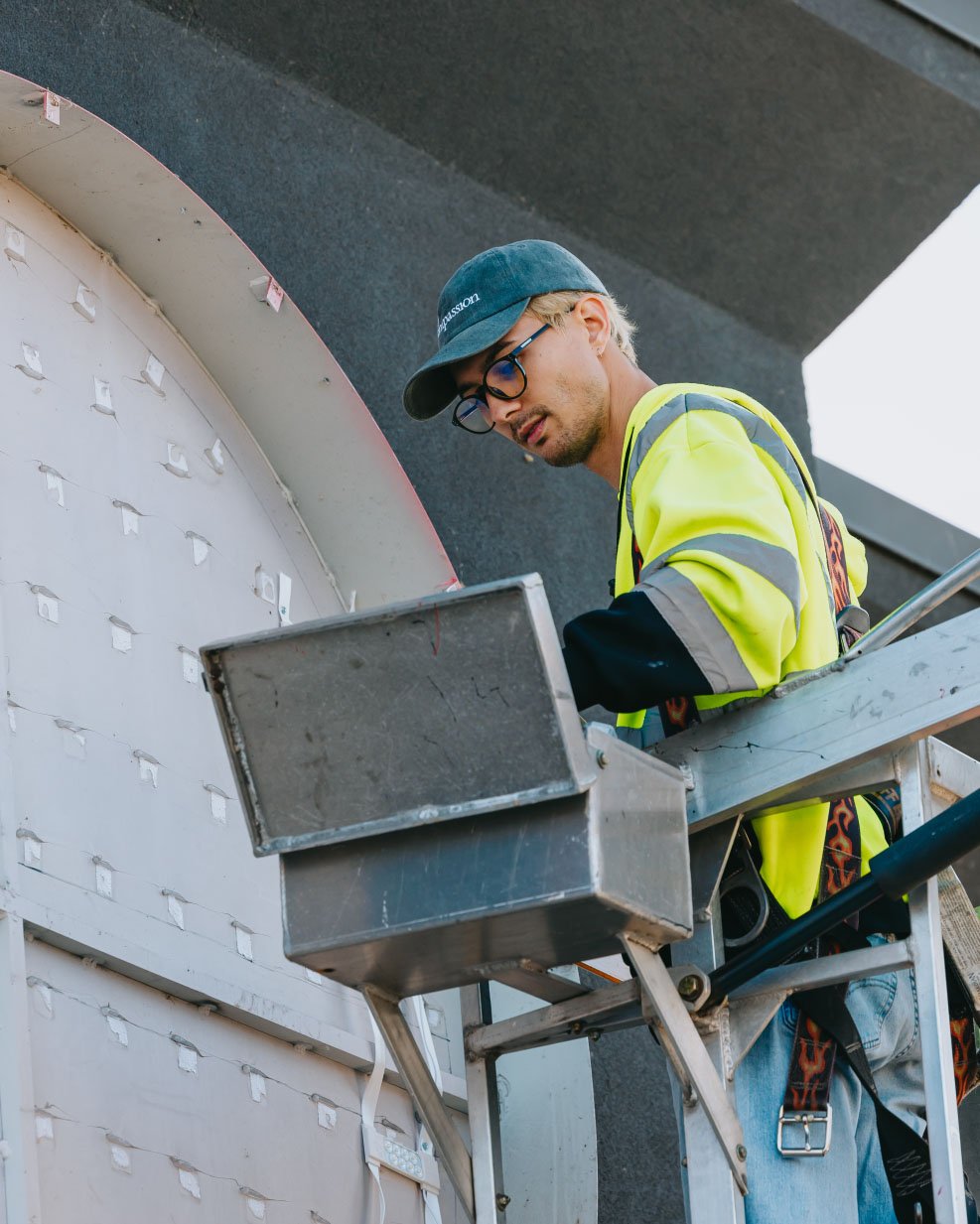 Rick Signs technician at the bucket truck lift controls during a Chicago sign service call