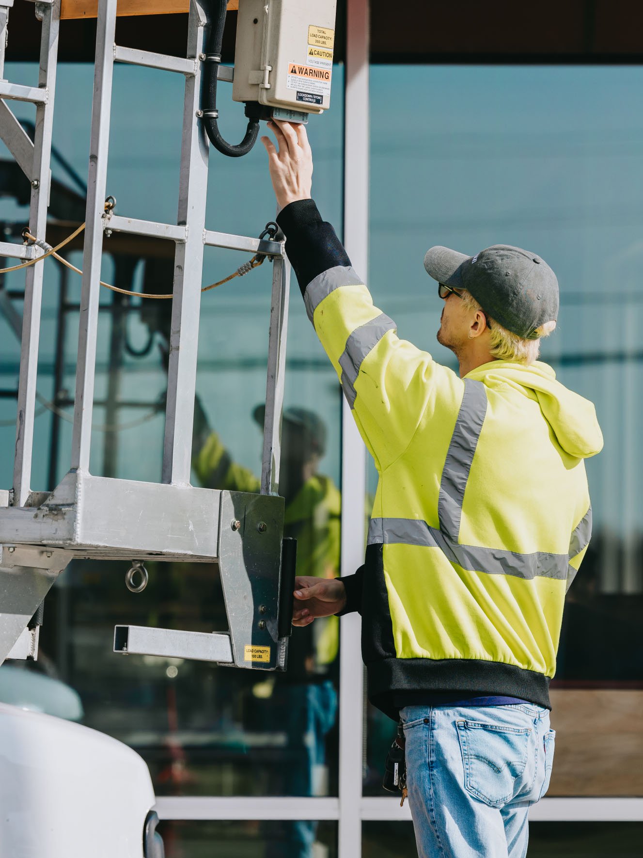 Two Rick Signs technicians coordinating during a commercial sign install in Chicago