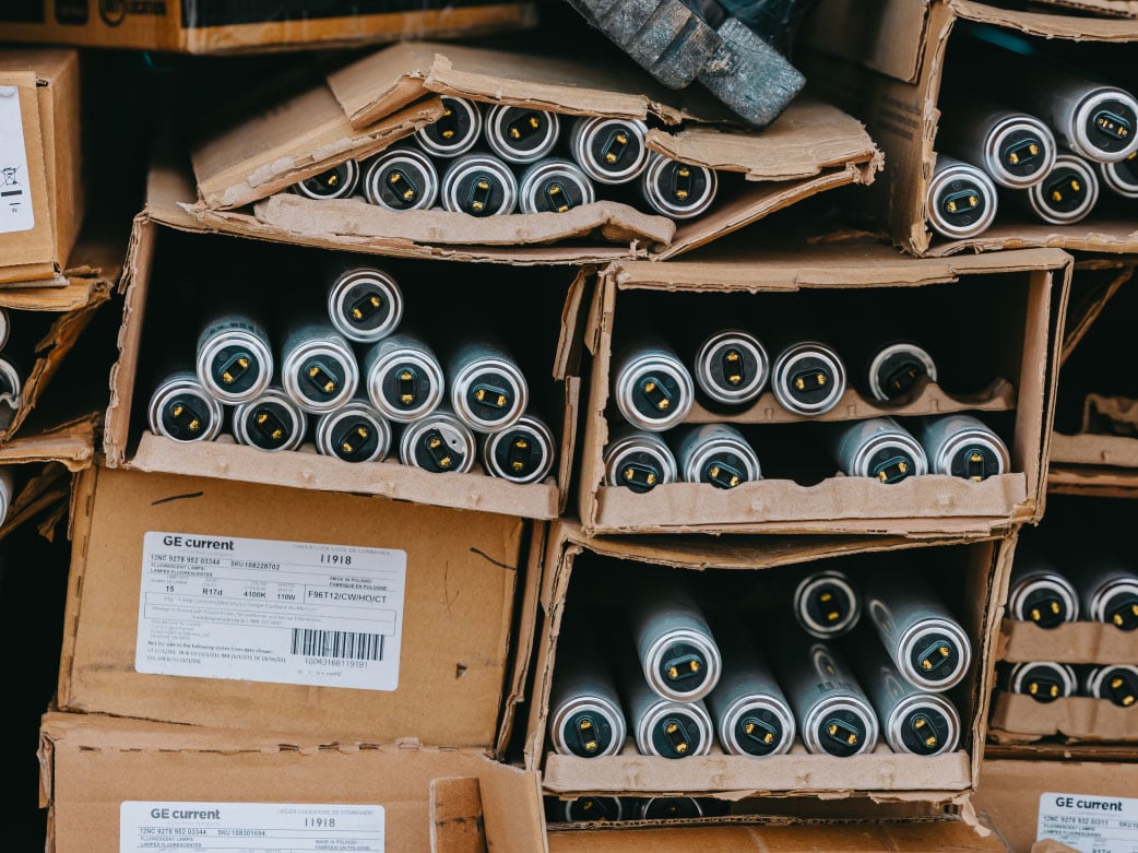 Boxes of fluorescent tubes and replacement bulbs in the Rick Signs shop inventory — Chicago