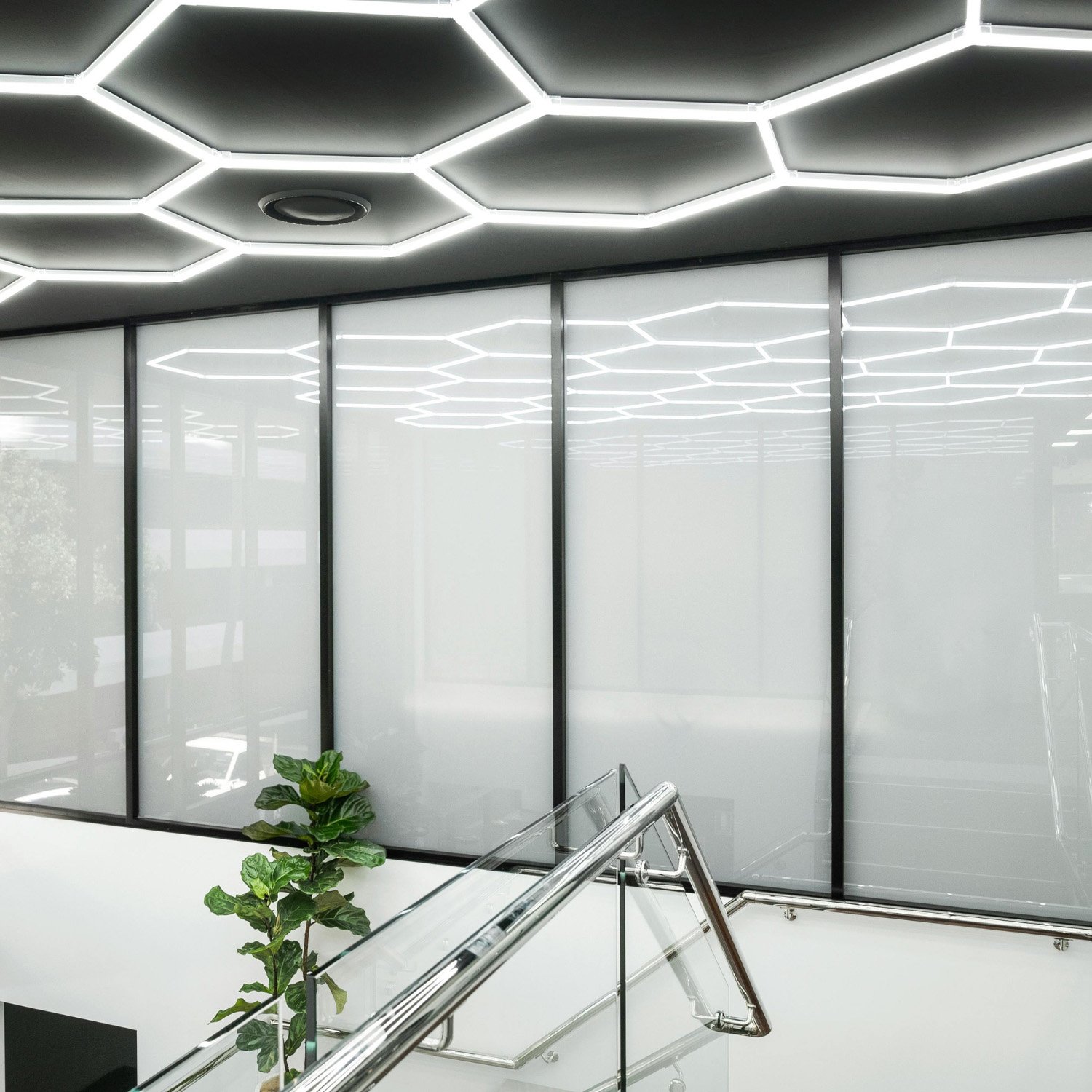 Modern office interior with hexagonal LED ceiling light fixtures — office lighting service for Chicago businesses