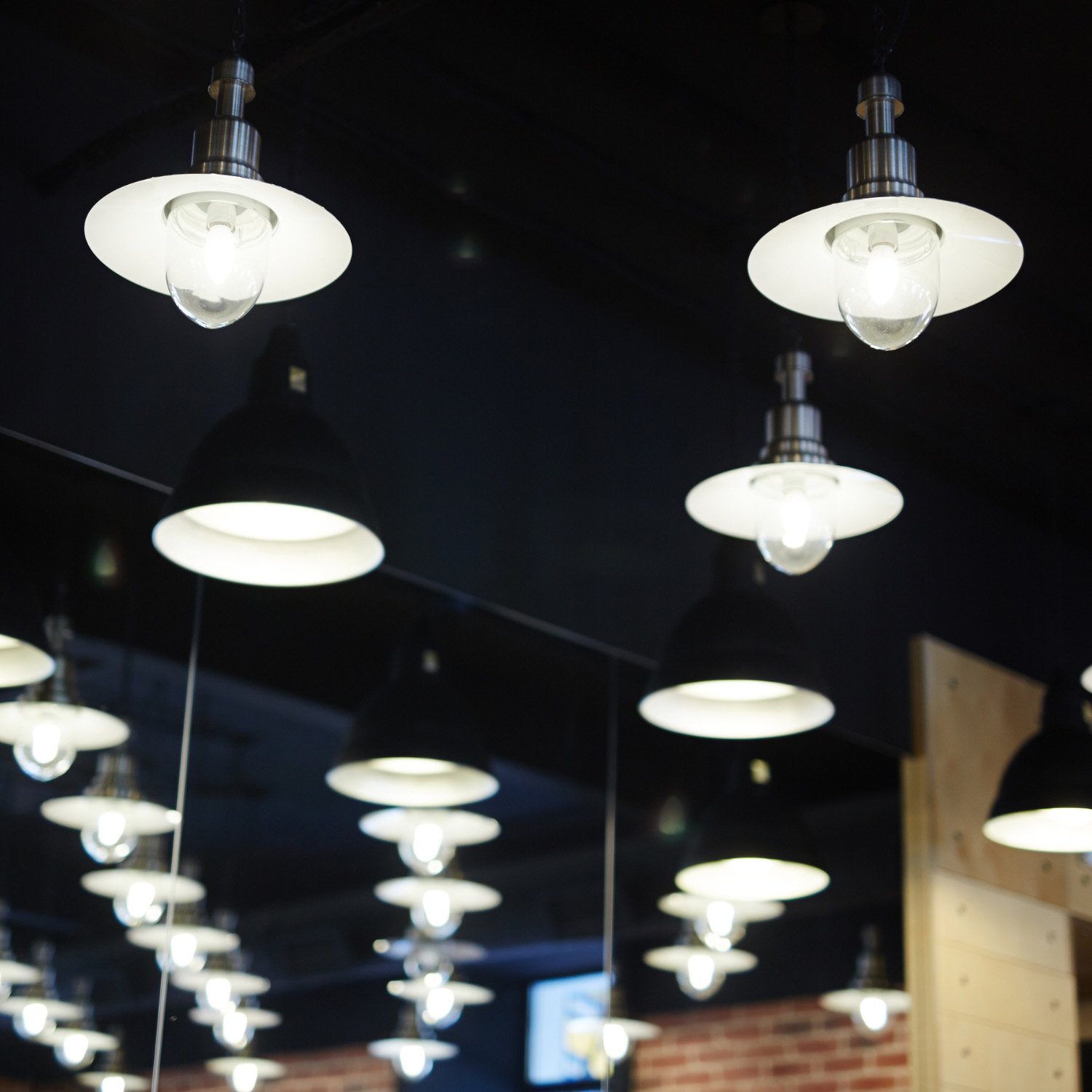 Industrial pendant light fixtures in a restaurant interior — commercial pendant lighting service for Chicago hospitality