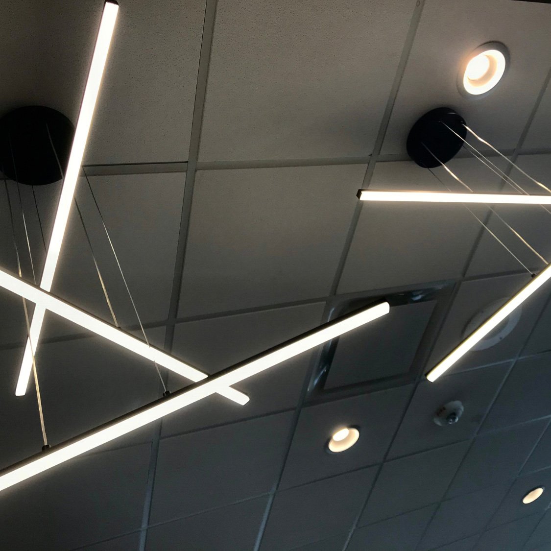 Modern commercial interior with linear LED downlights and track lighting — interior lighting maintenance Chicago
