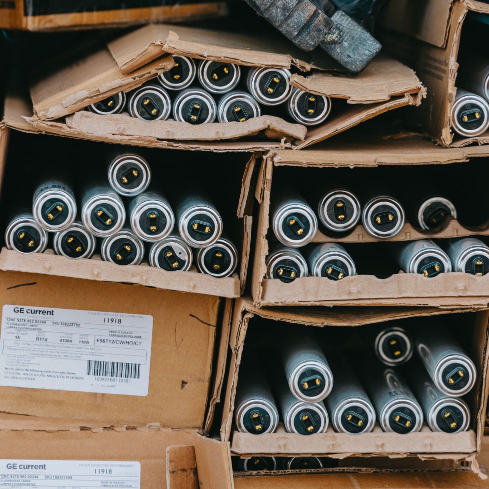 Boxes of fluorescent bulbs and sign lighting parts at the Rick Signs shop — Chicago sign and lighting inventory