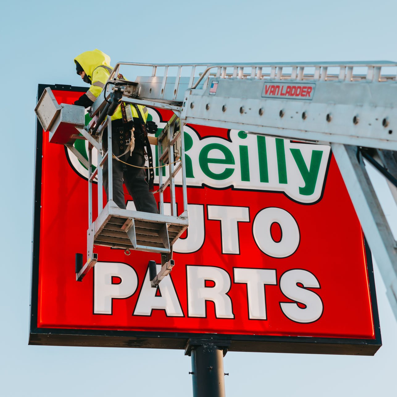 Close-up of the illuminated O’Reilly Auto Parts cabinet sign mounted on a high pole — Rick Signs repair Chicago
