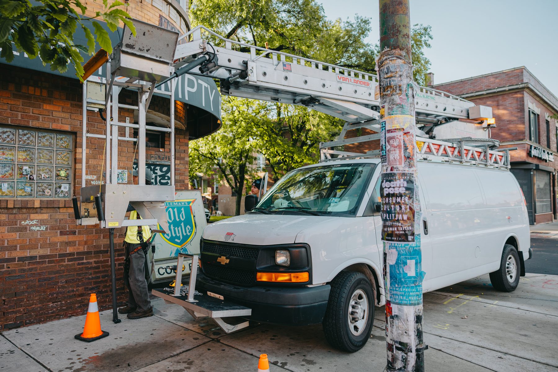 Rick Signs & Repairs van and bucket truck parked outside Empty Bottle during the sign installation in Chicago