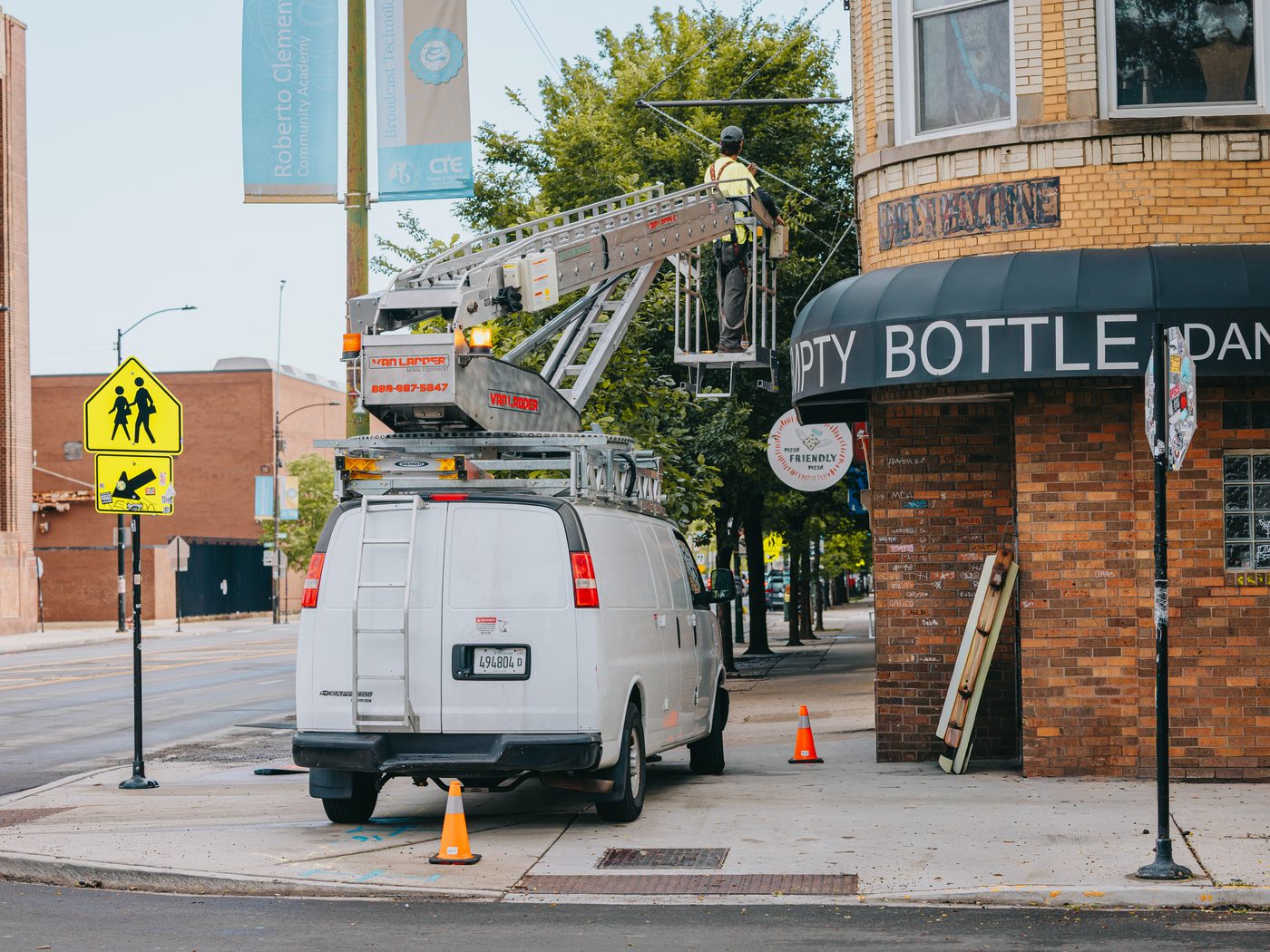 Rick Signs service van and bucket truck at the Empty Bottle corner marquee on North Western Avenue in Ukrainian Village, Chicago