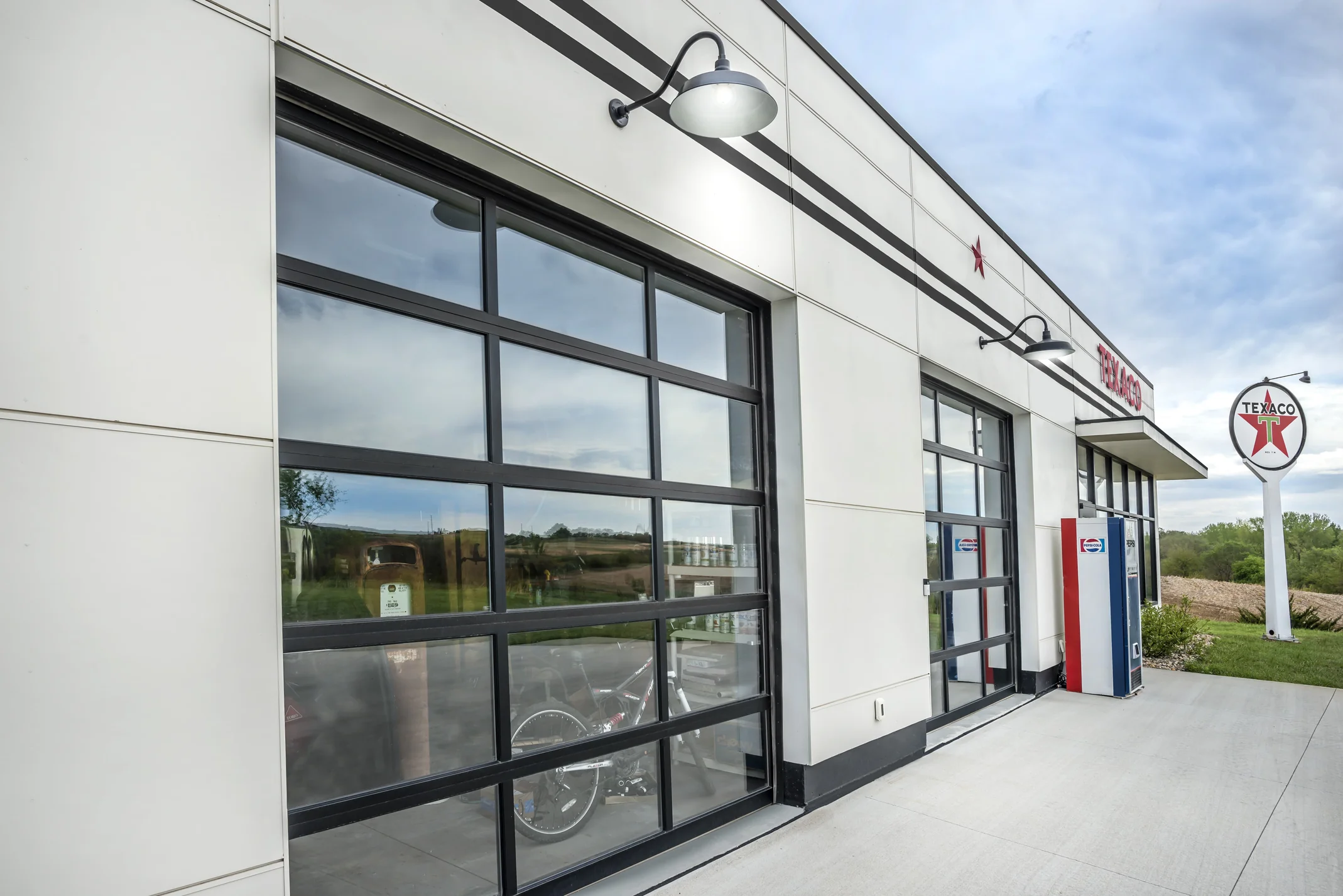 Facade detail with glass doors at the Texaco-themed station, Scott Hill Texaco project