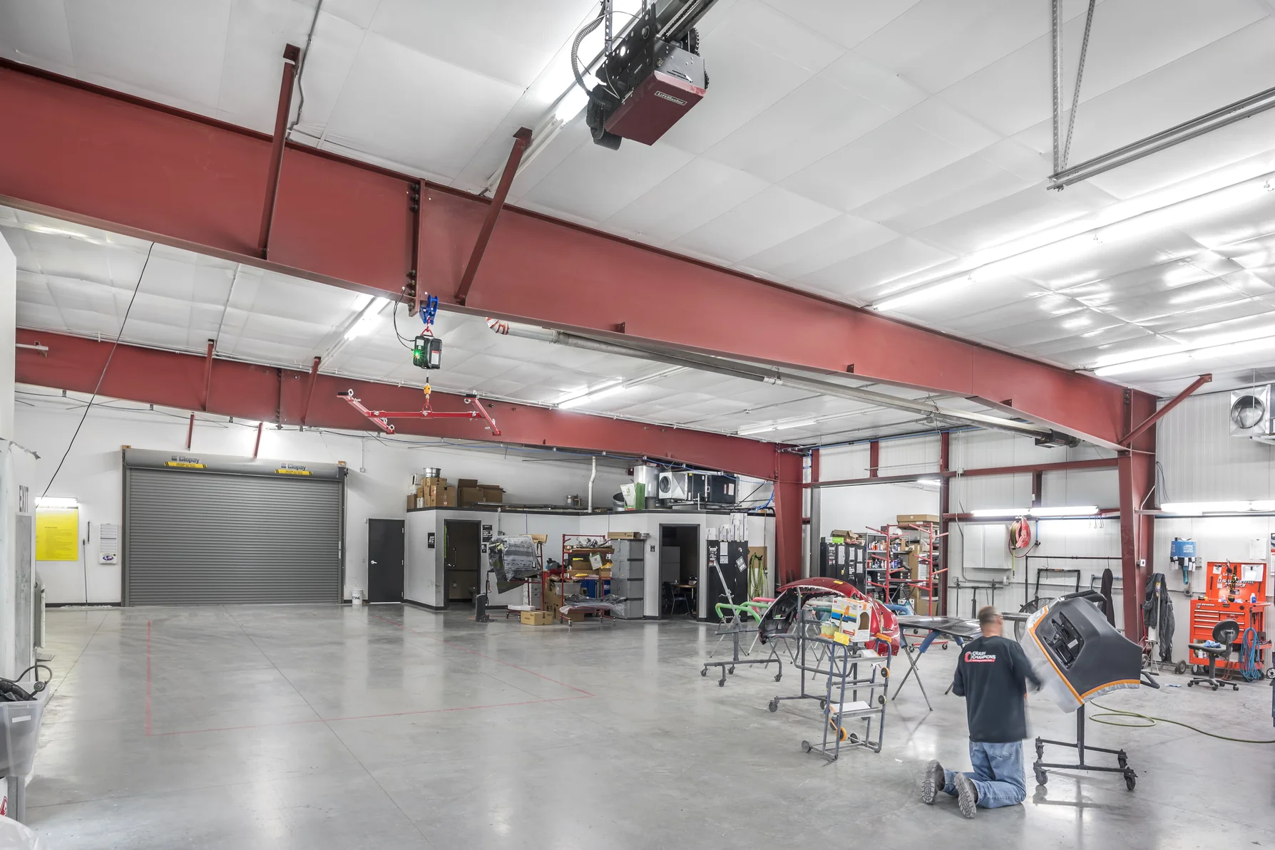 Technician performing body work inside the Crash Champions collision repair shop