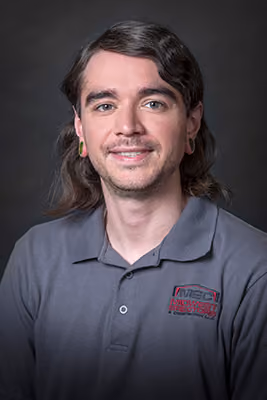 Headshot of a Midwest Erectors crew member with long dark wavy hair and an earring, wearing a gray company polo, additional photo