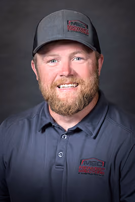 Headshot of a Midwest Erectors crew member with a reddish beard, wearing a gray company cap and polo, alternate photo