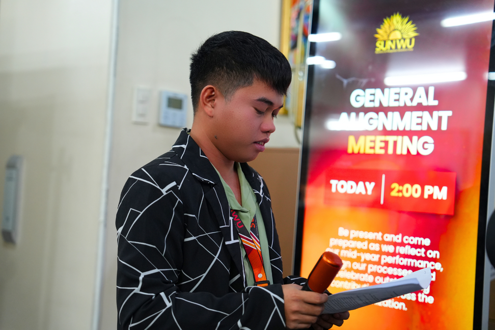 Team member reading from notes during presentation