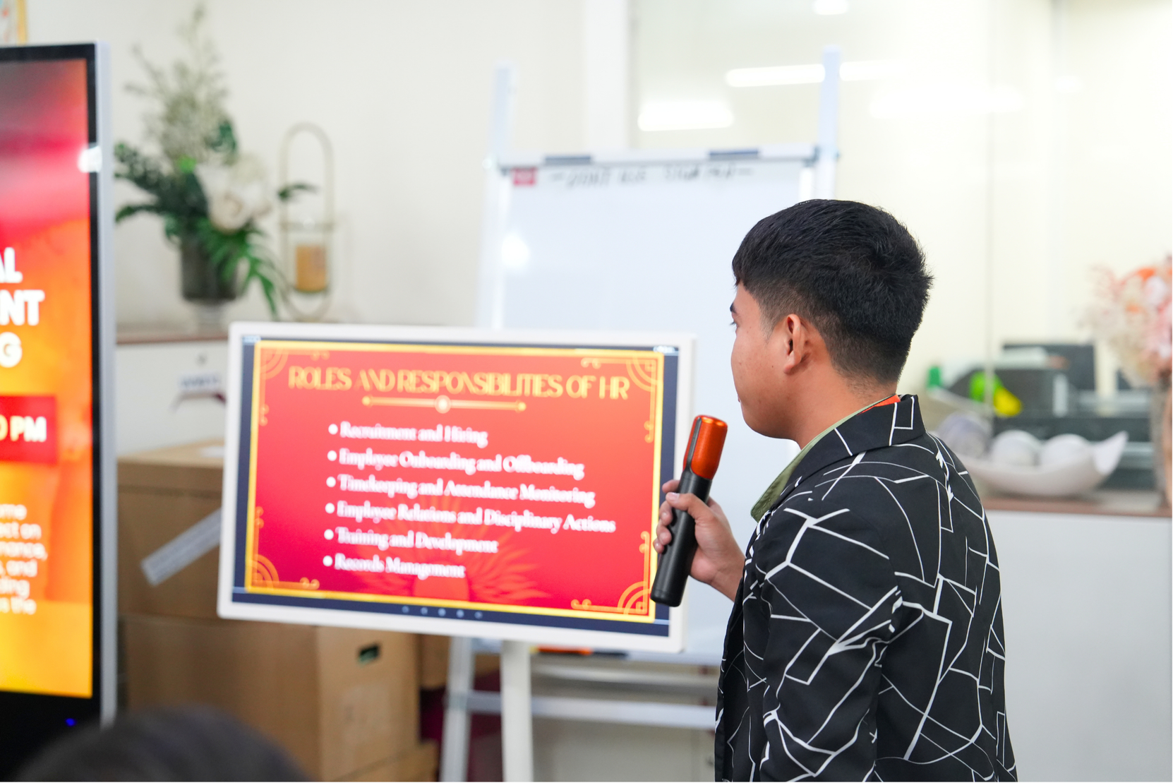 Presenter pointing to workflow diagram on screen