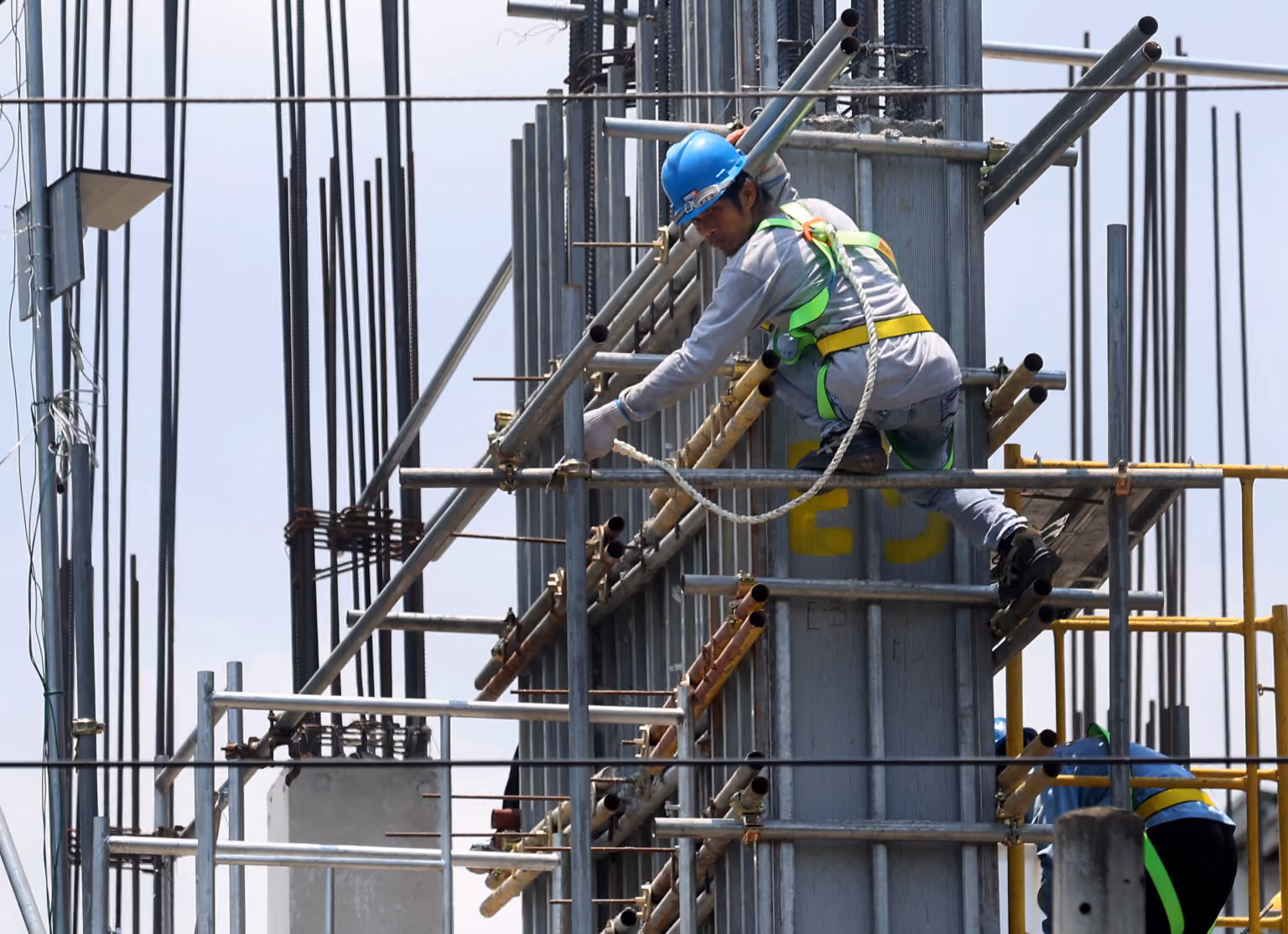 Construction worker on scaffolding at a building site