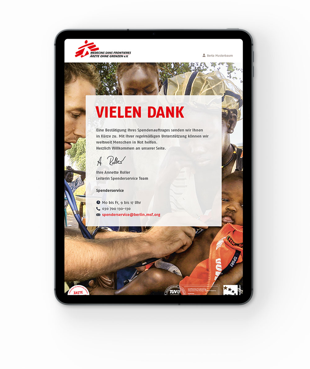 Tablet showing a thank you message from Ärzte ohne Grenzen with a photo of a doctor examining a child.
