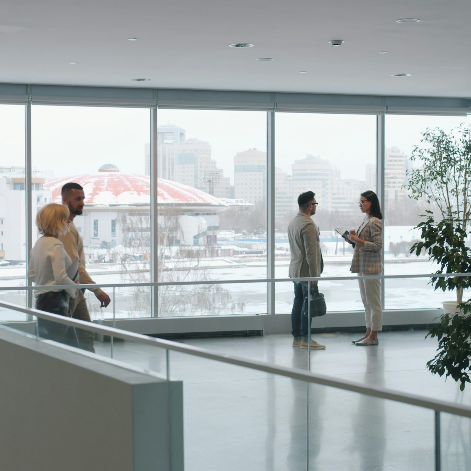 Professionals meeting in a light-filled modern office atrium