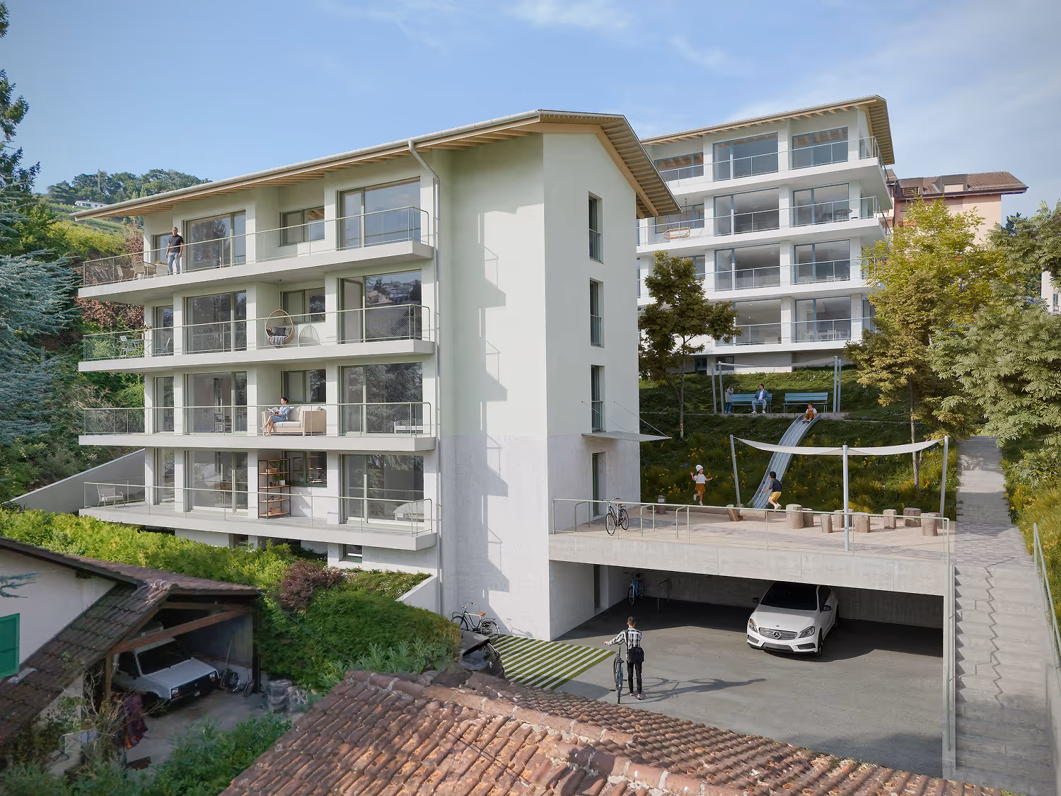 Résidence moderne avec balcons, parking, aire de jeux et verdure autour.