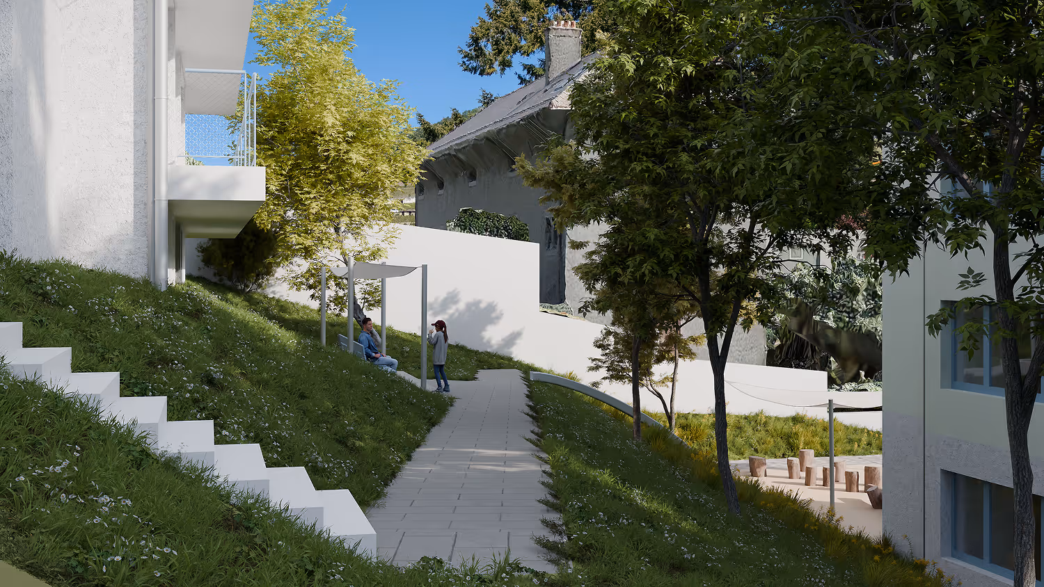 Deux personnes discutent sur un chemin pavé entre deux bâtiments modernes avec arbres et pelouse.