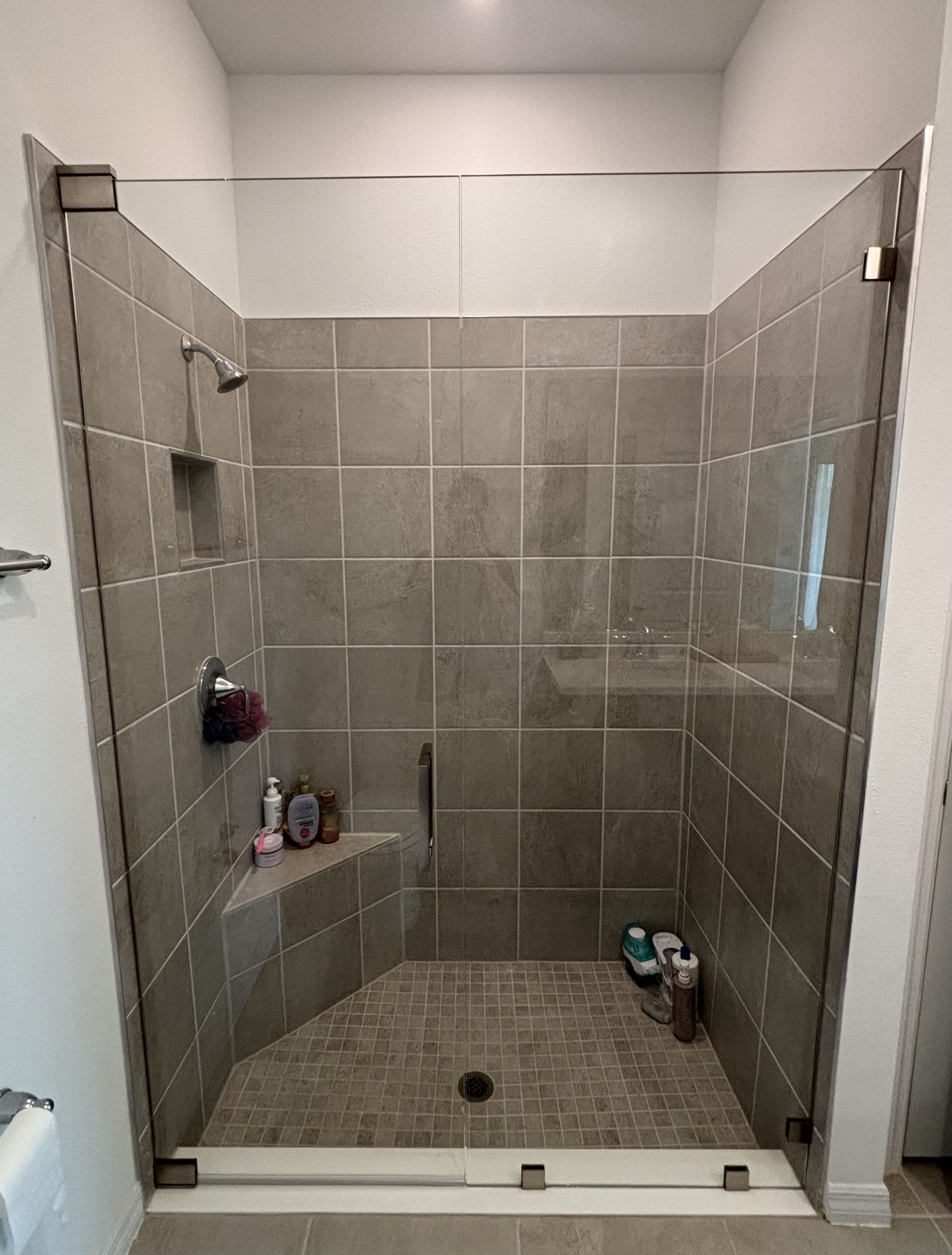 Completed custom frameless shower glass enclosure in a Tampa Bay bathroom