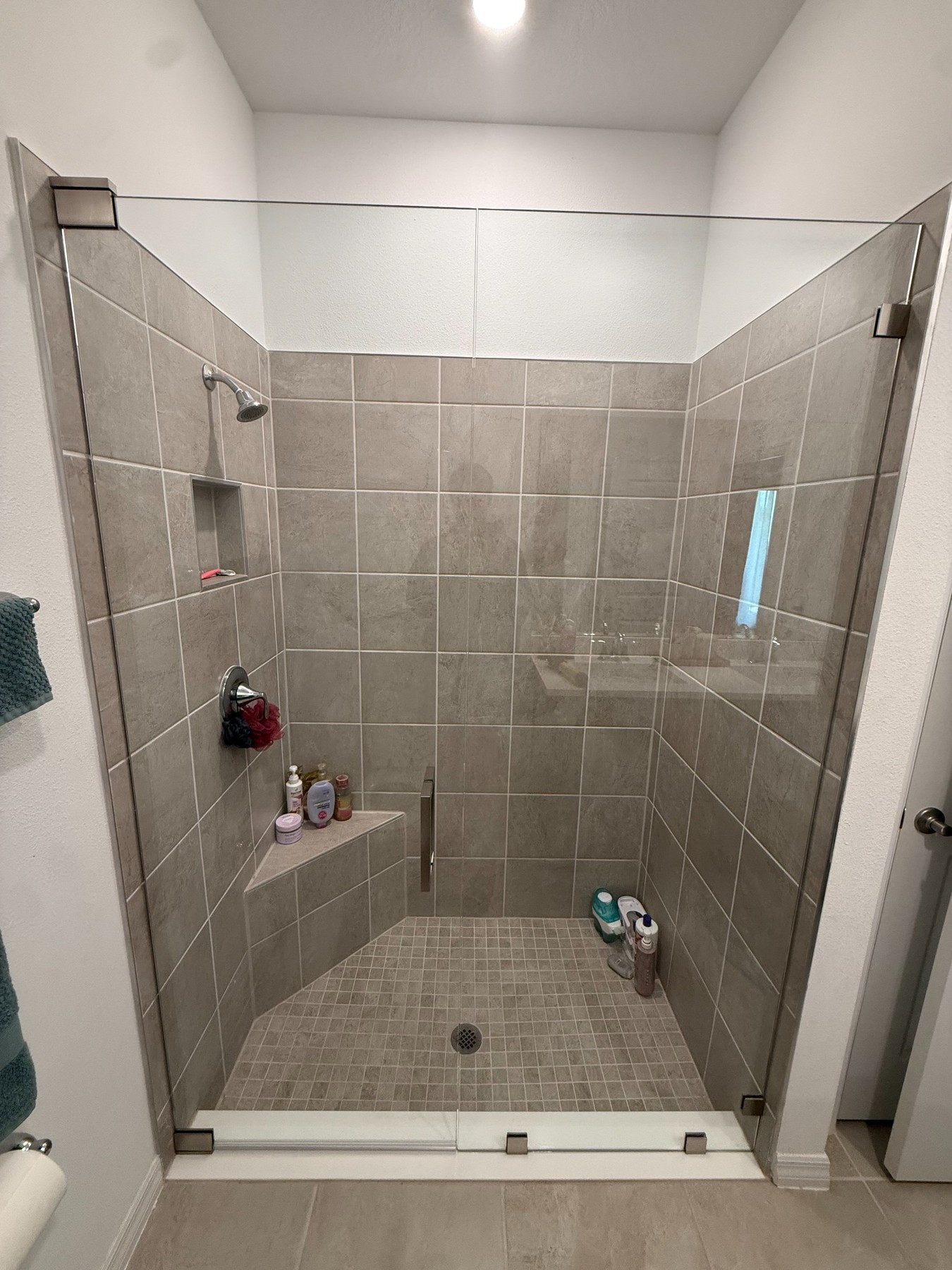 Before and after frameless sliding shower door installation in Tampa Bay