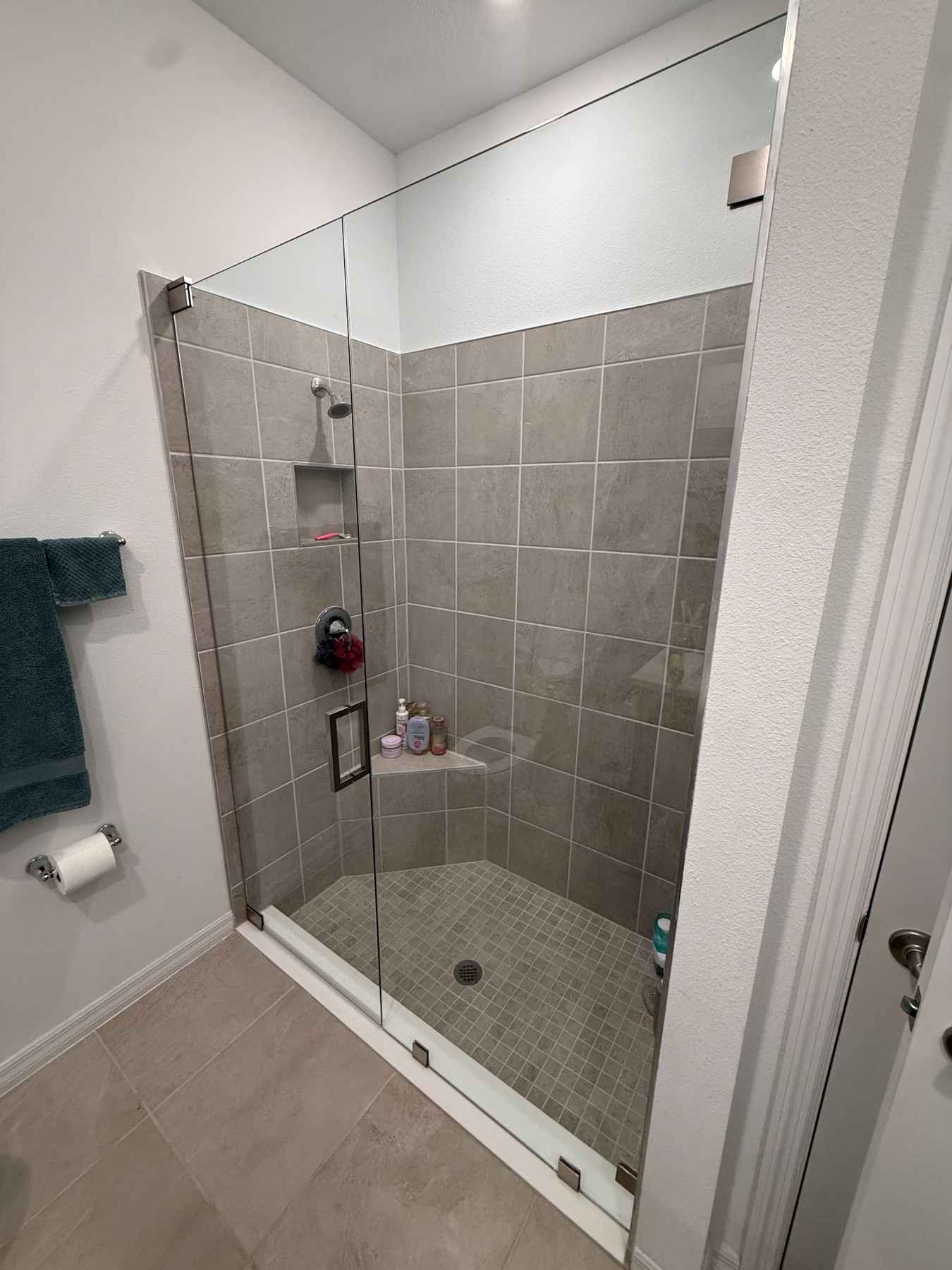 Before and after frameless sliding shower door installation in Tampa Bay