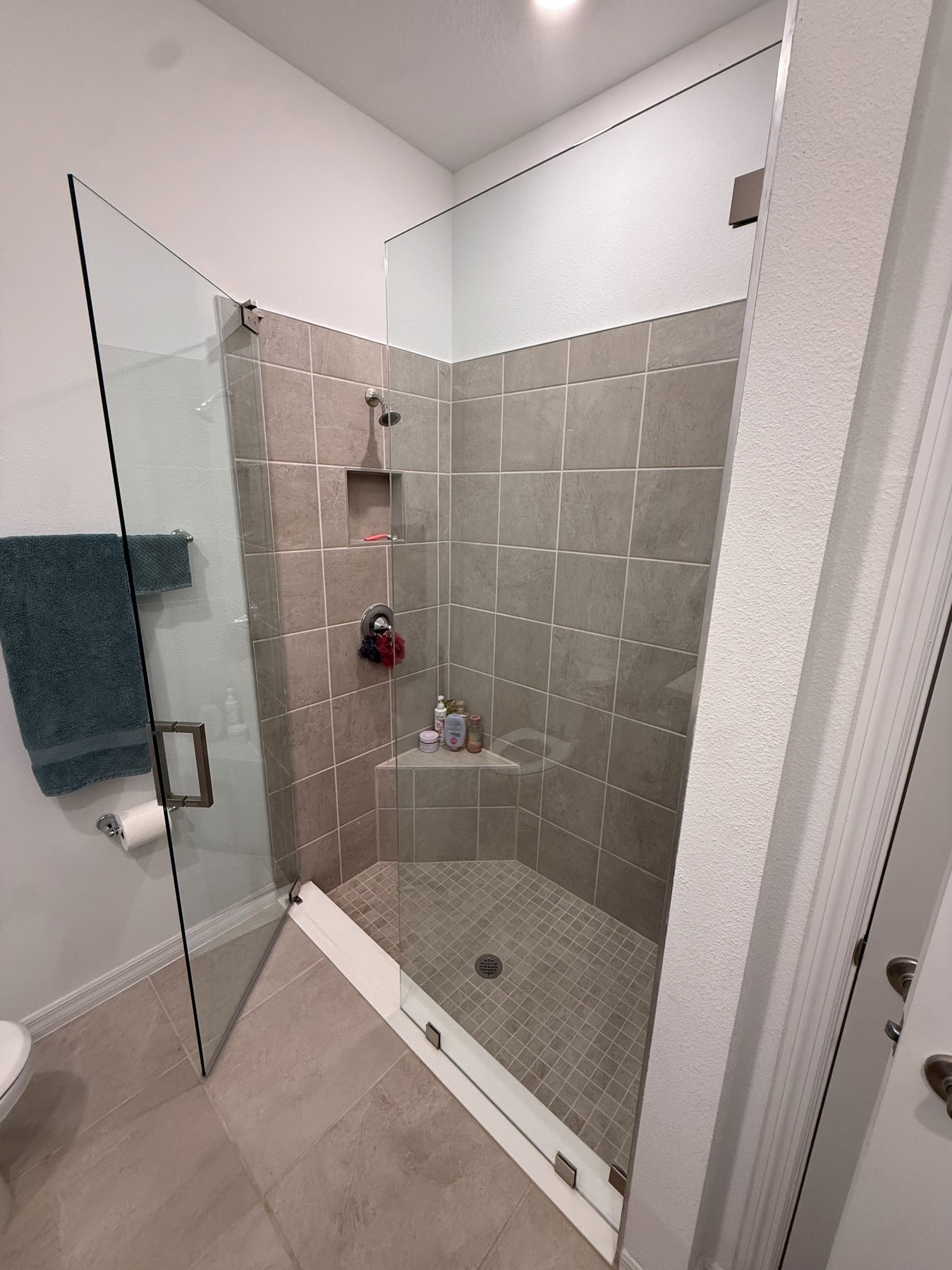 Before and after frameless sliding shower door installation in Tampa Bay