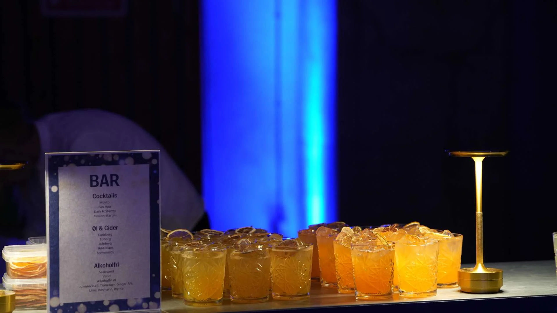 Chef slicing white truffle over creamy pasta served in a white bowl with gold rim.