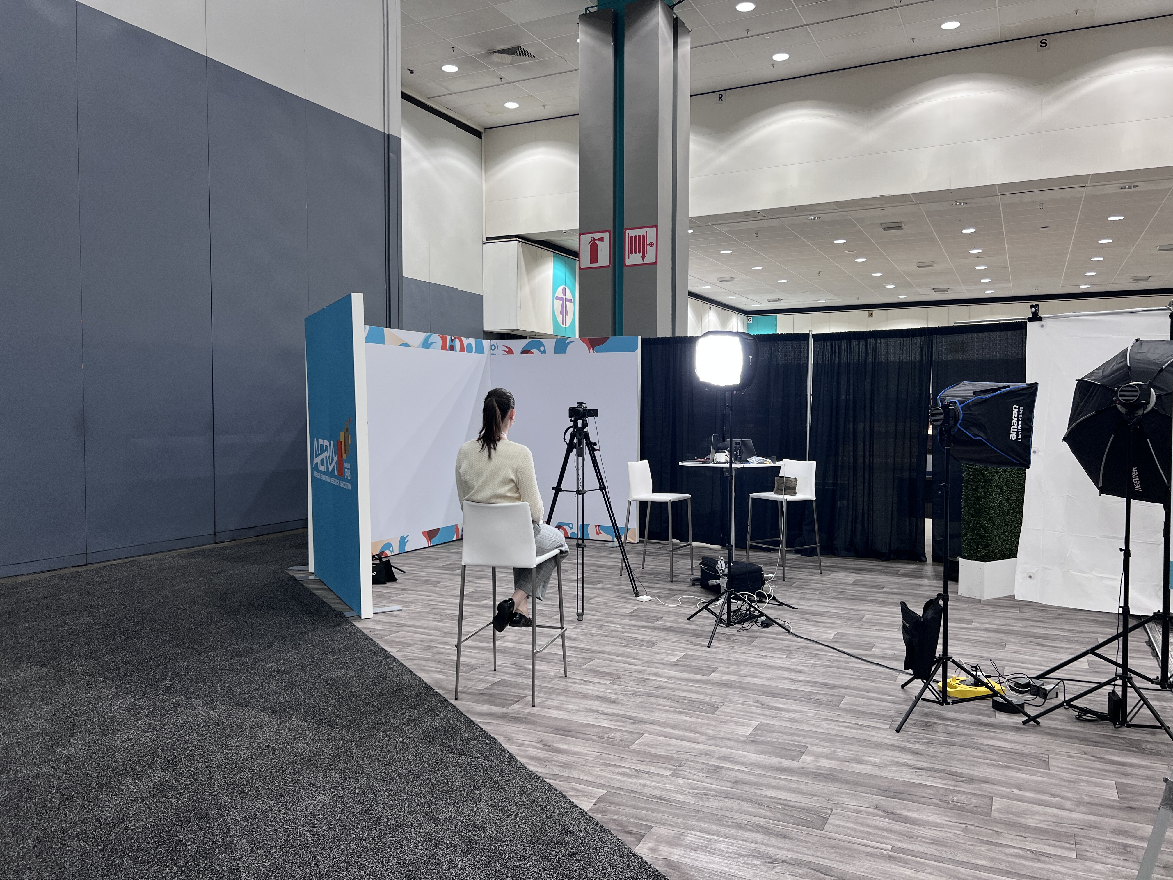 AERA branded video booth with lighting and camera equipment at the conference