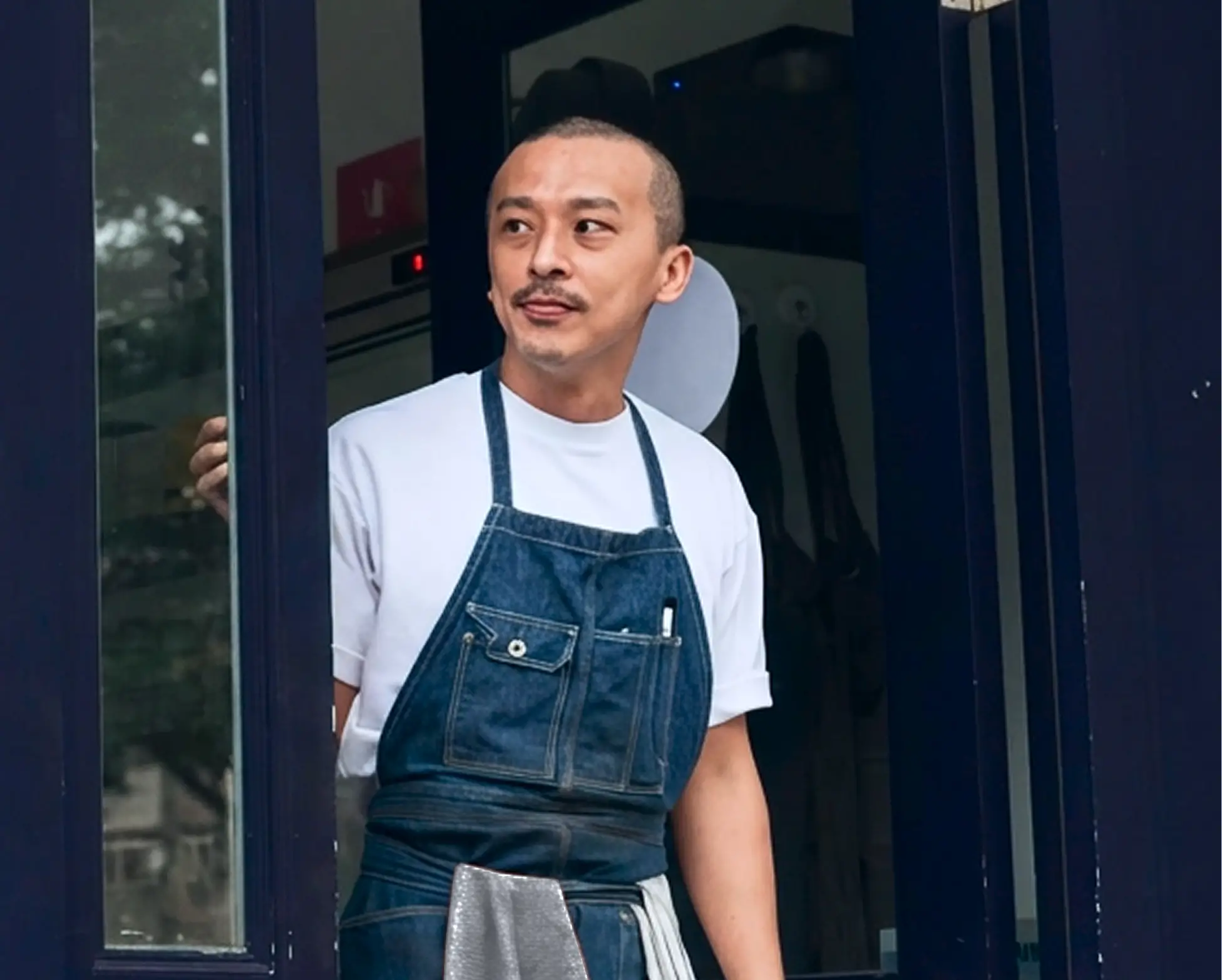 A man standing outside of a store.