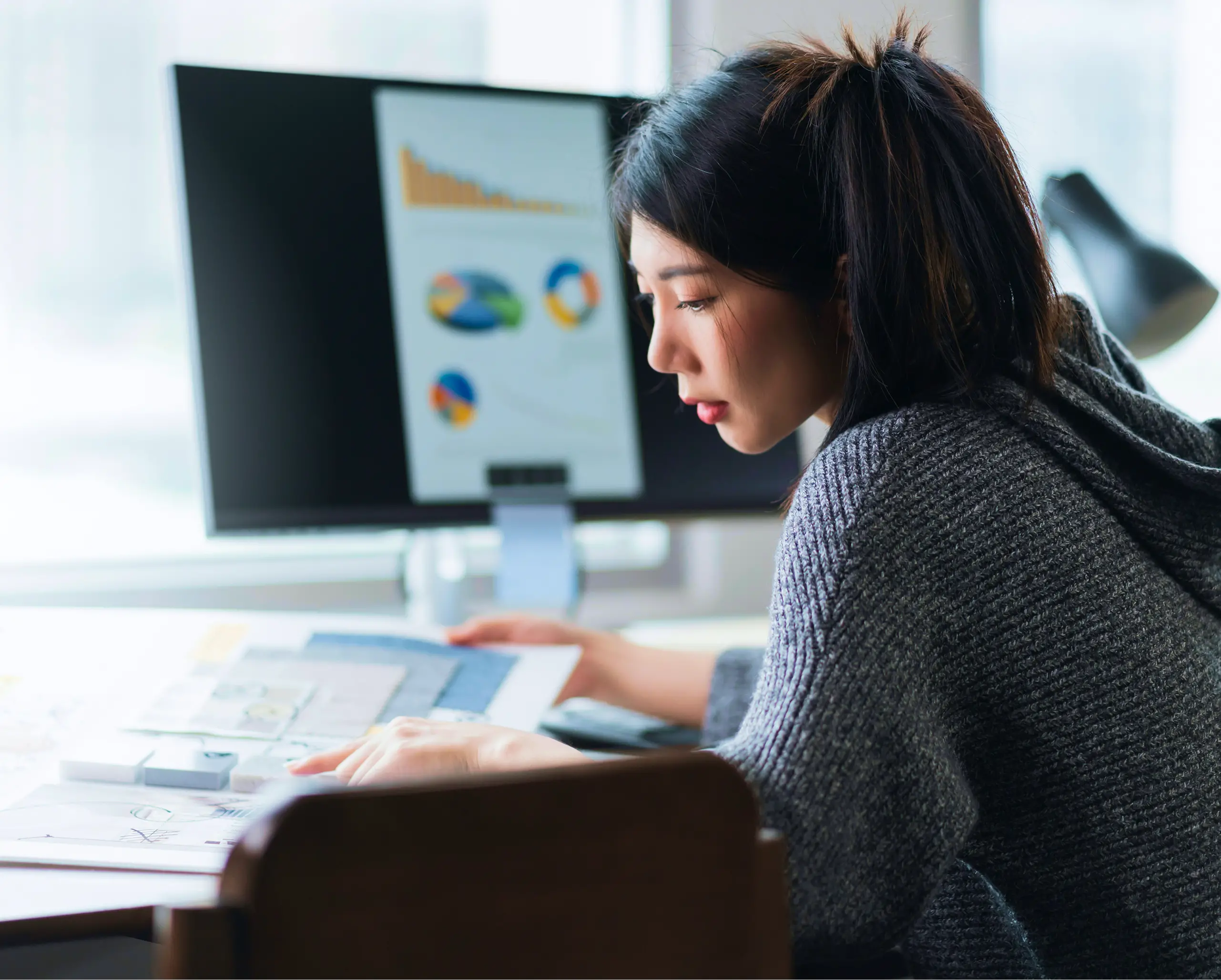 A woman looking through data information in a binder.