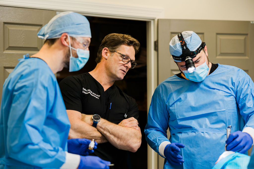 Dr. Rick Kapitan, founder, lead surgeon. and dental implant maxillofacial specialist mentoring two oral surgeons