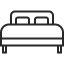Icon of a bed with a headboard and two pillows.