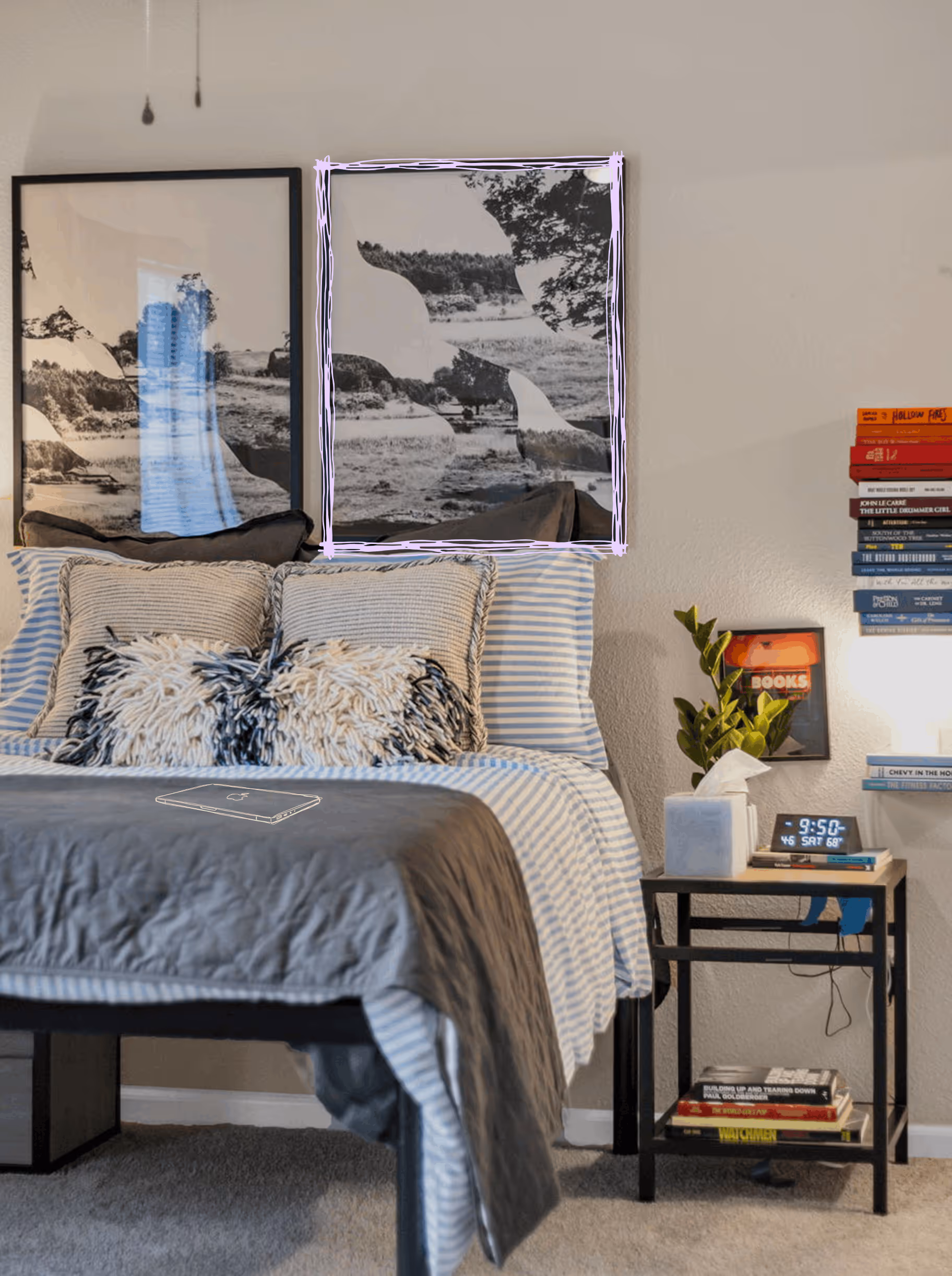 Cozy bedroom with striped bedding, textured pillows, black and white landscape art above the bed, and a bedside table with books, tissue box, plant, and digital clock showing 9:50.