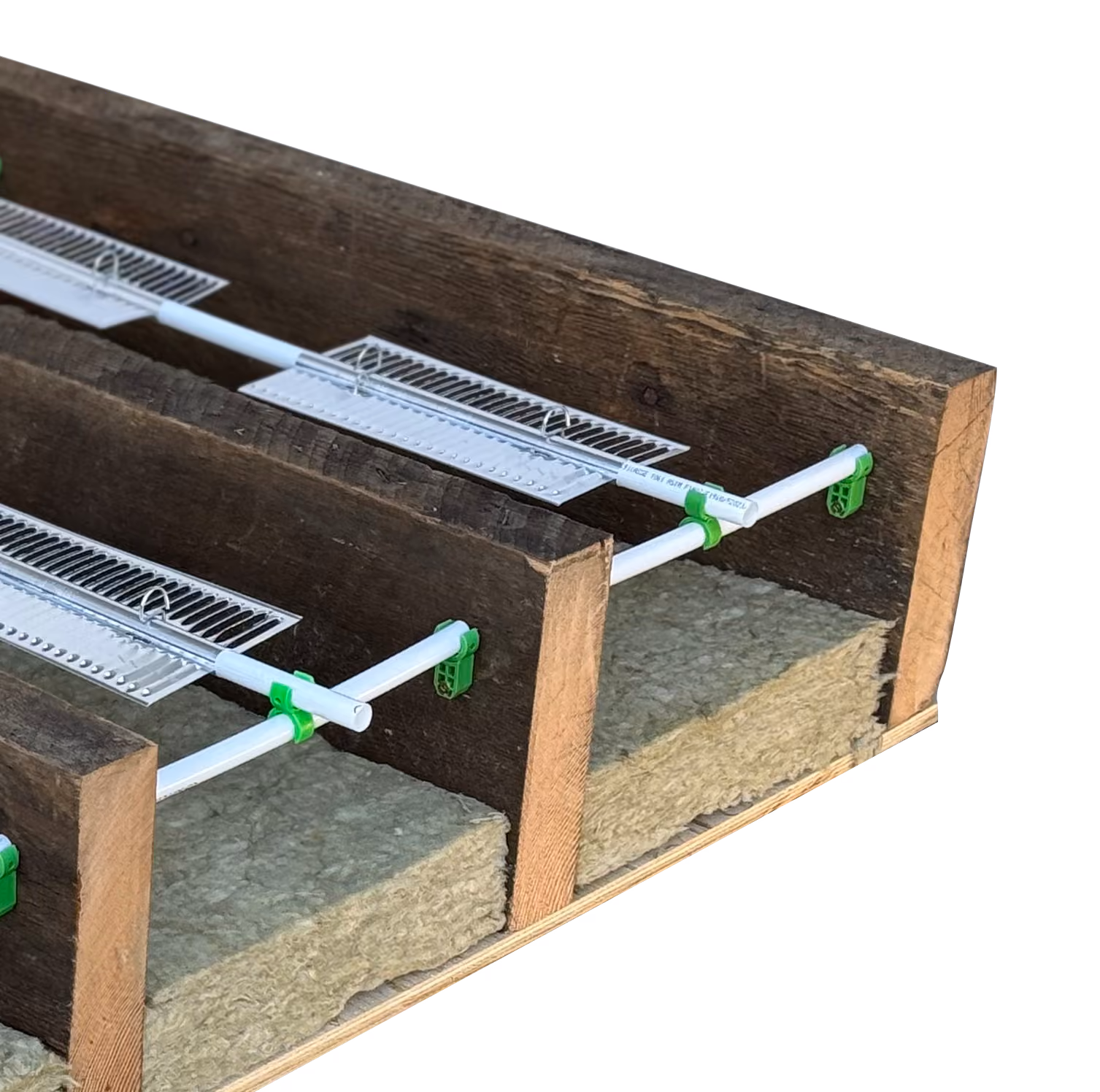Wooden structure with green clips holding white horizontal rods above insulation material.