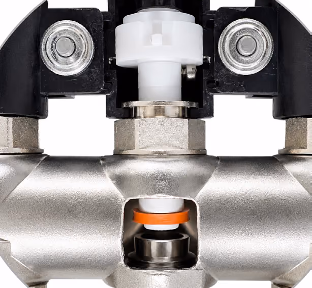 Close-up of a metallic valve with white plastic and orange ring components.