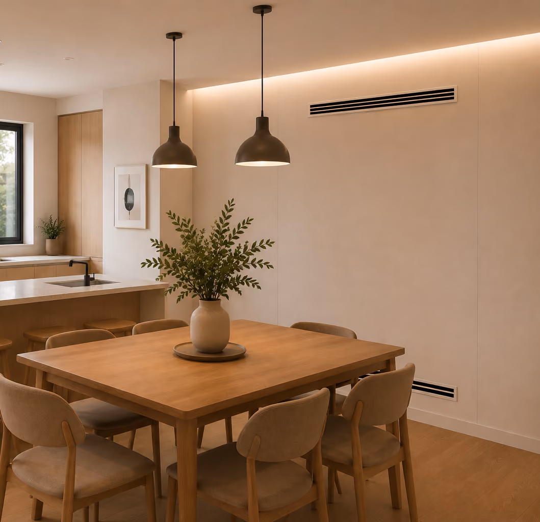 Modern dining room with wooden table, beige chairs, hanging lights, and a plant centerpiece.
