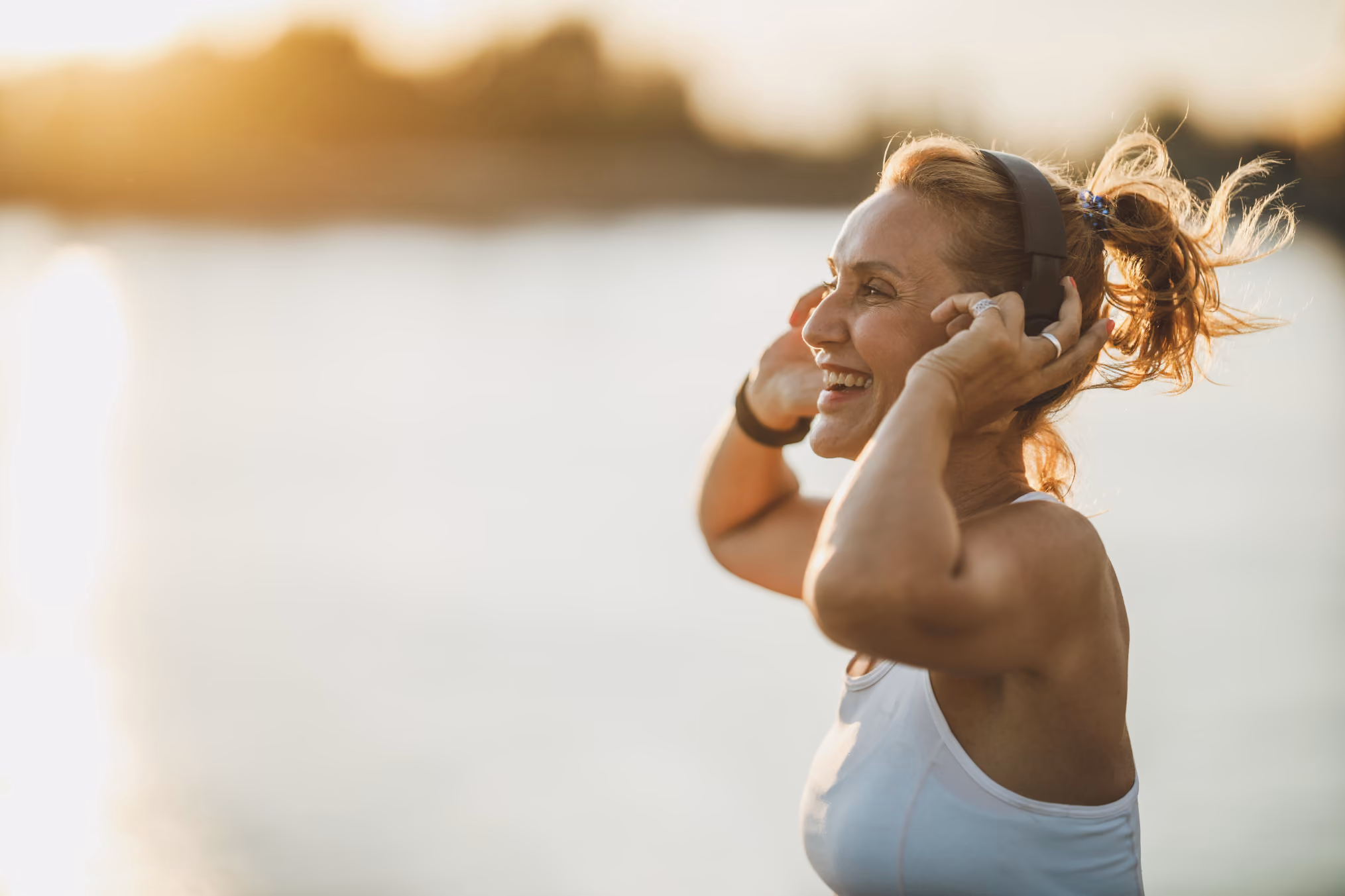 Woman outdoors in athletic gear with headphones stock image