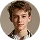 Headshot of a young man with short light brown hair and a neutral expression.