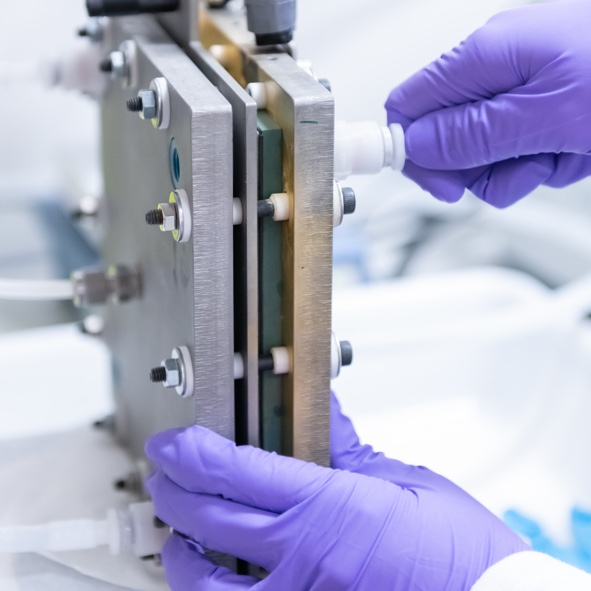 fuel cell and purple gloved hands