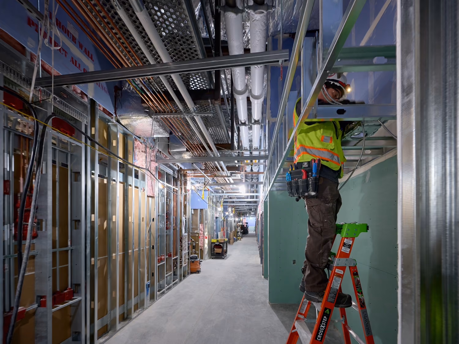Electrician working on interior conduit and wiring