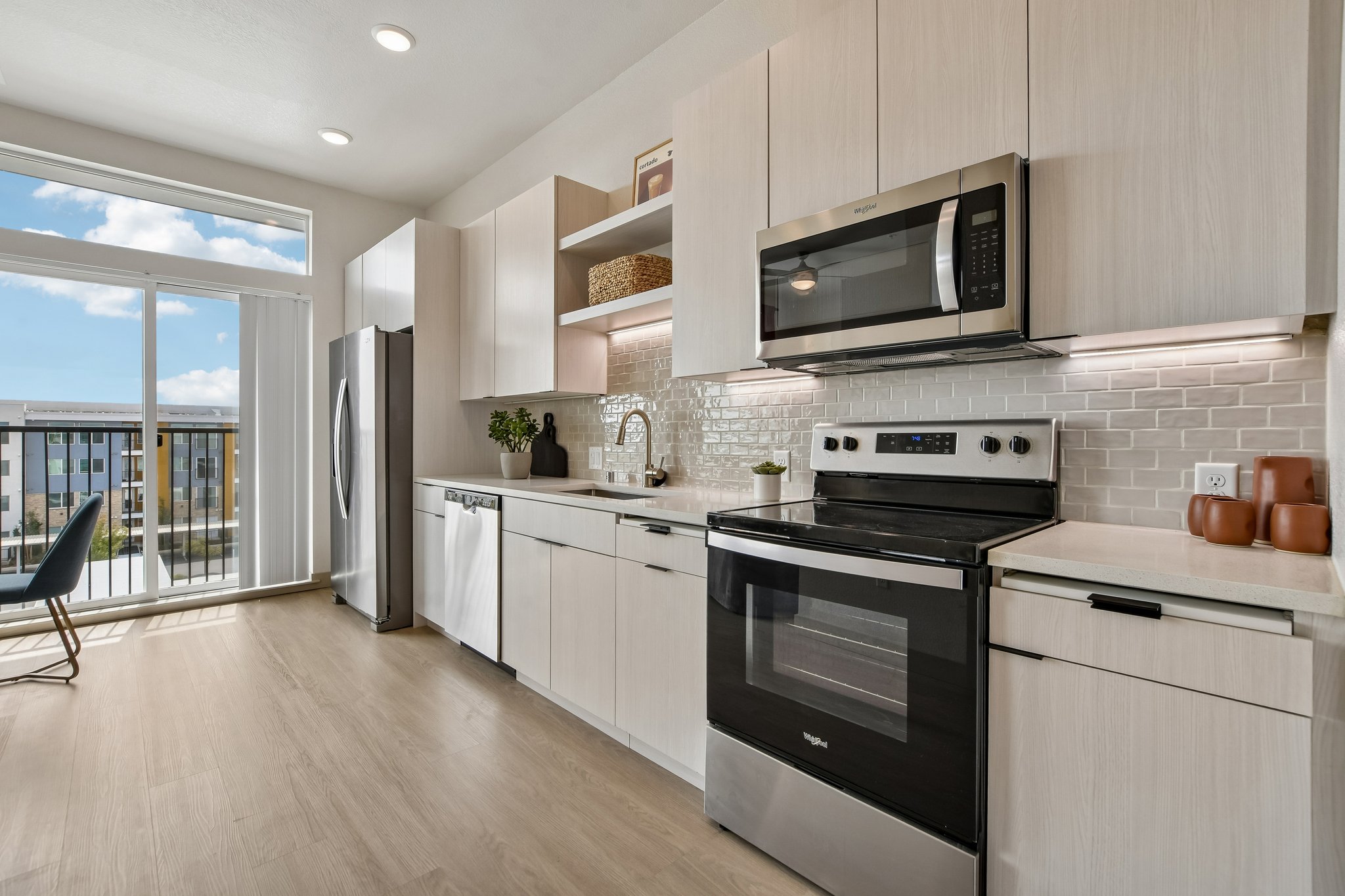 Kitchen with cream cabinets and white counters
