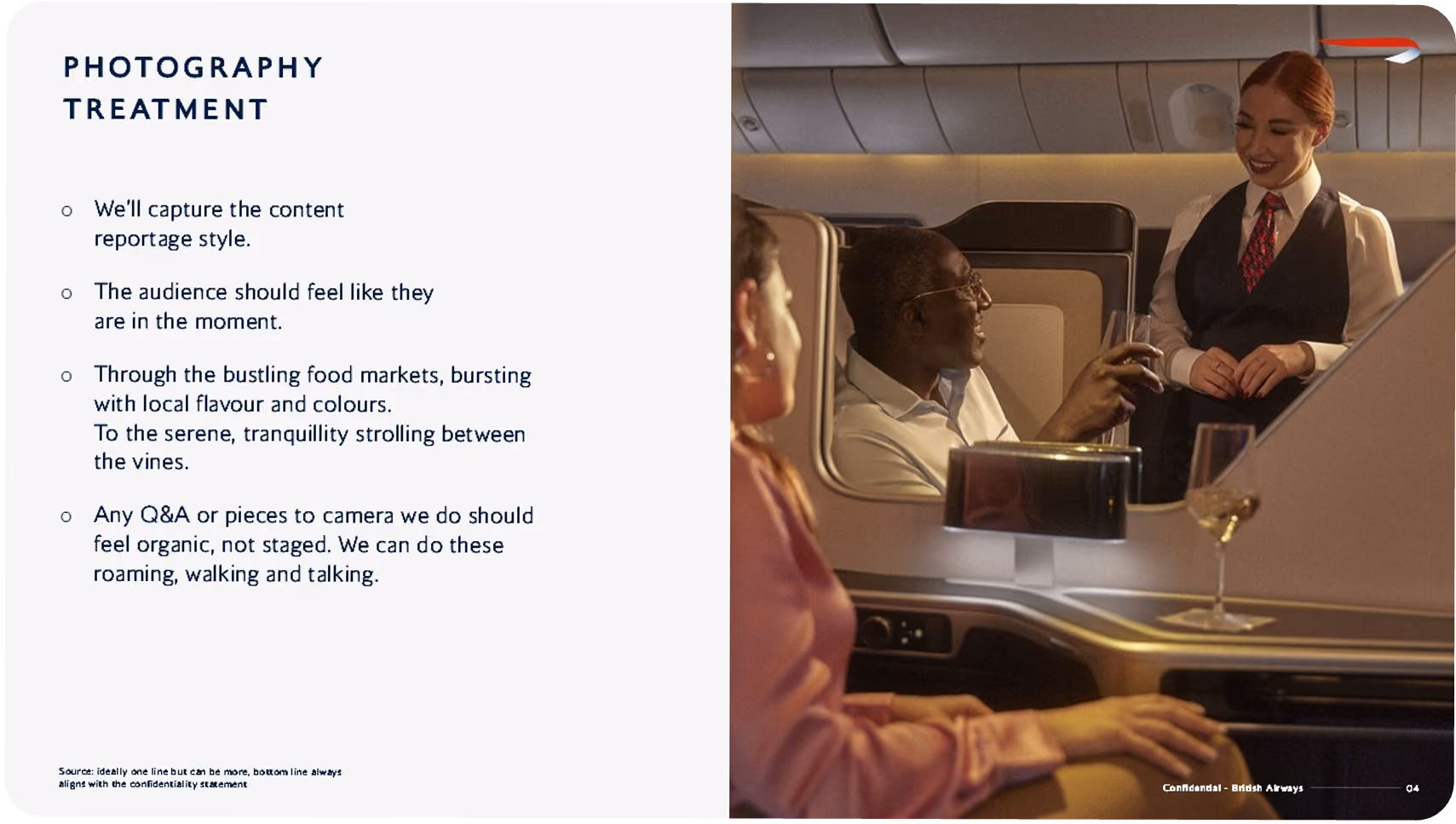 Two passengers seated in an airplane cabin talking with a smiling flight attendant in uniform.