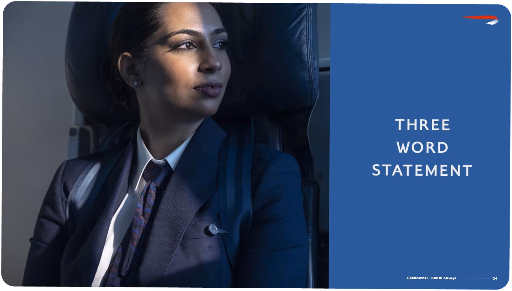 Female British Airways pilot in uniform sitting and looking out an airplane window.