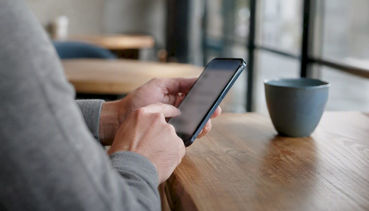 Hands interacting with smartphone form