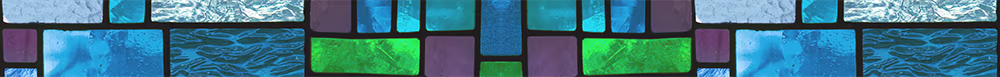 Close-up of a mosaic pattern featuring rectangular glass tiles in various shades of blue, green, and purple with textured surfaces resembling water and waves.