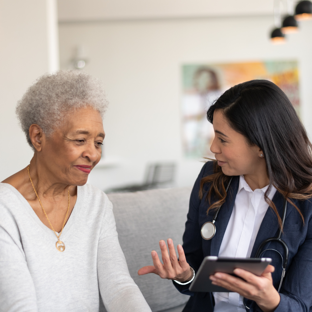 A smiling nurse with an older patient