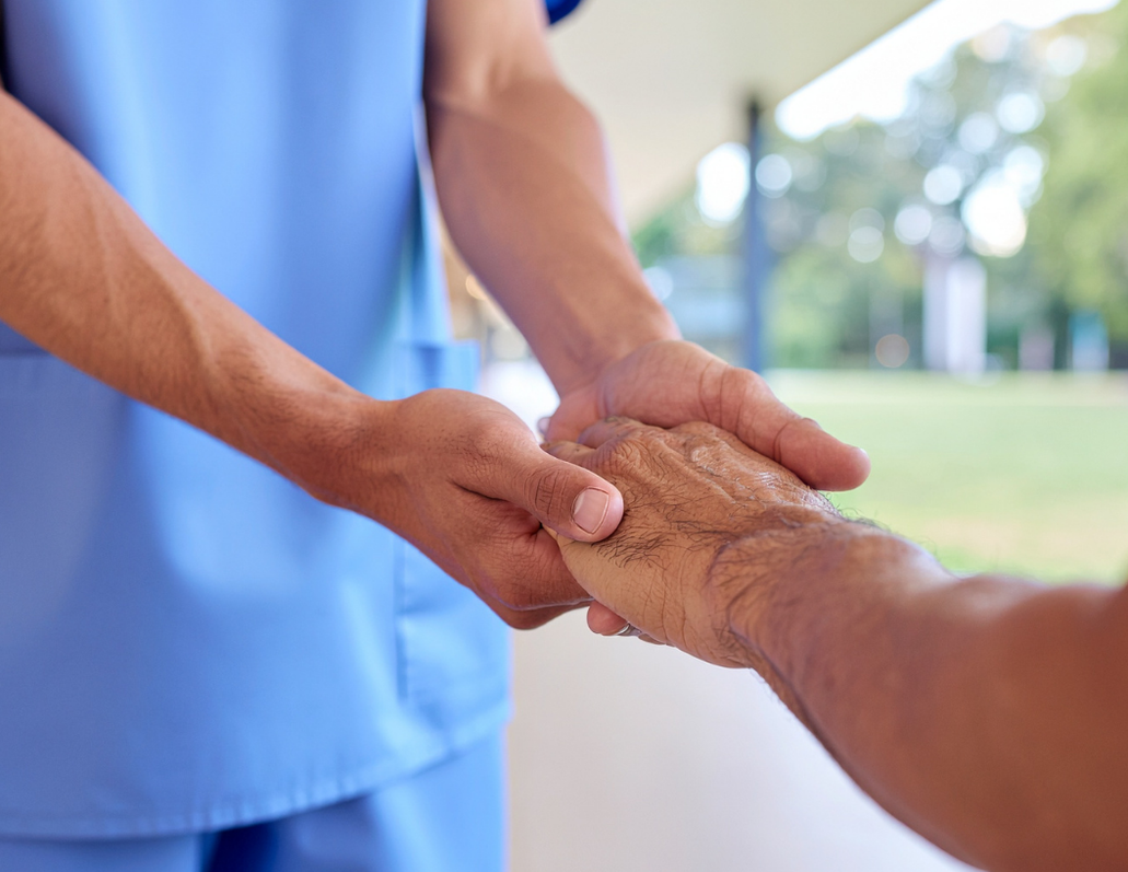 A caregiver holding an older person's hand